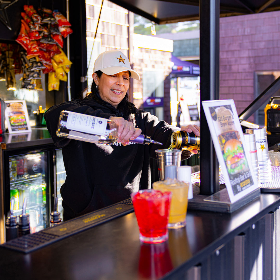 Bartender Pouring Drinks for Customers at Heavenly Rockstar Bar & Grill