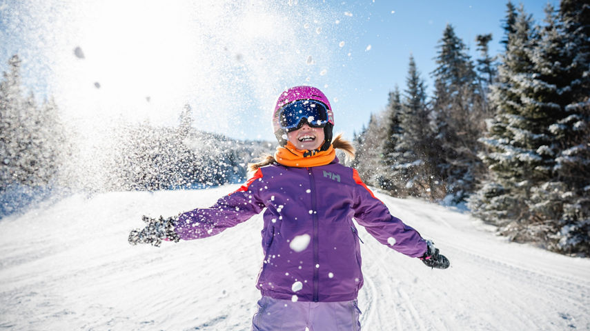 Young Girl Throws Snow in the Air to Celebrate a Moment of Excitement at Okemo