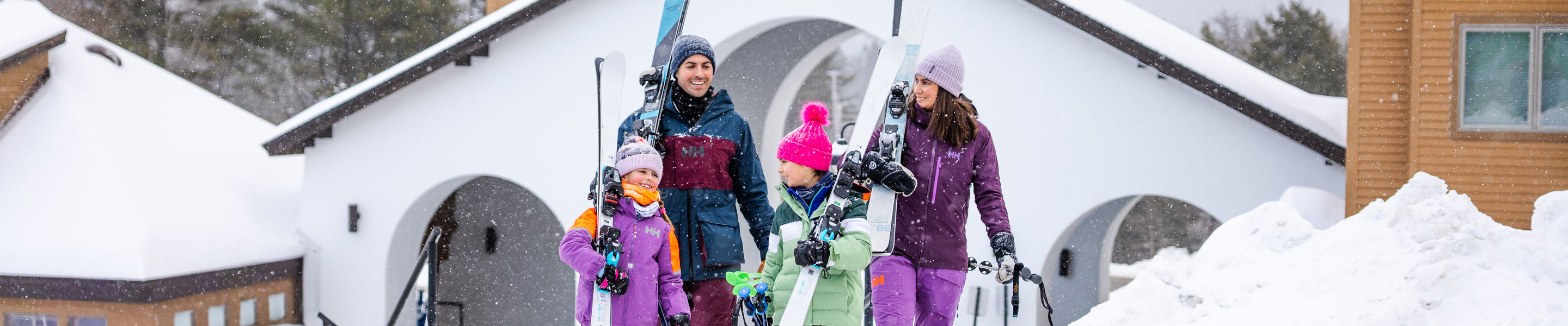 Family Carries Skis Through Okemo Village