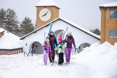 Family Carries Skis Through Okemo Village