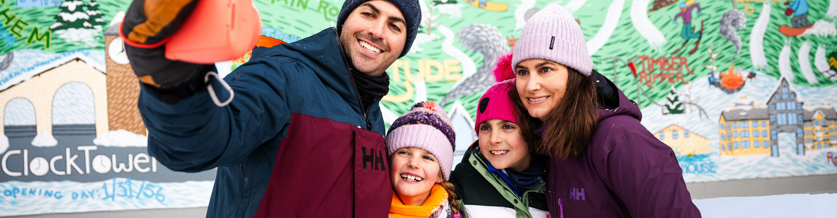 Family Takes an Instant Photo in Front of Okemo Anniversary Sign