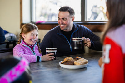 Family Enjoys Hot Cocoa and Sweets During Ski Break at Okemo