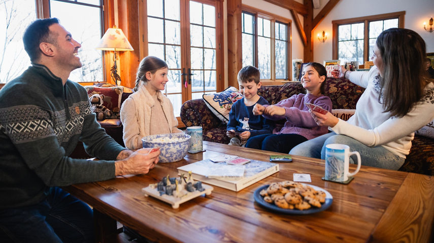 Family Enjoys Playing Games at Okemo Lodge After a Big Ski Day