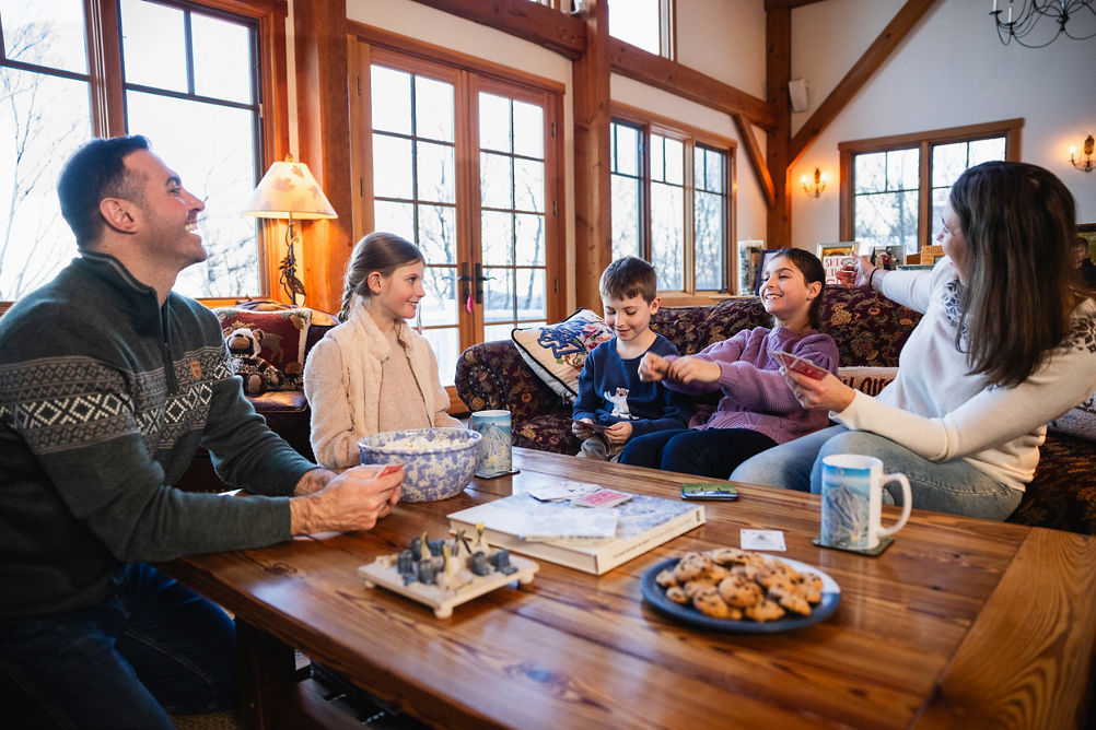 Family Enjoys Playing Games at Okemo Lodge After a Big Ski Day