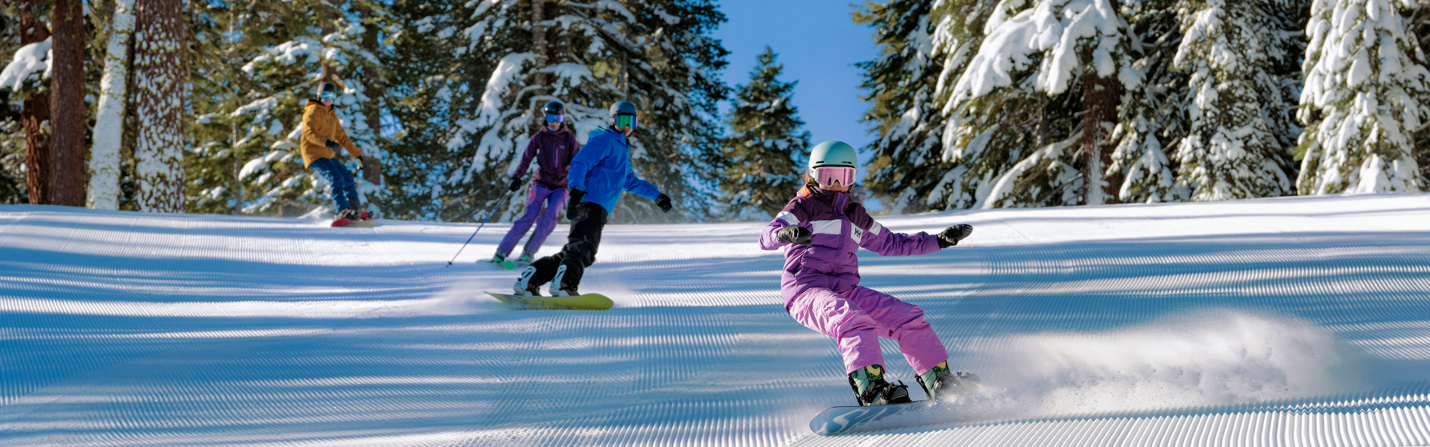 Family Skis Down Tree-Lined Trail at Northstar