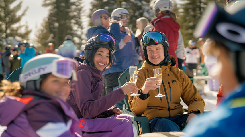 Family Smiling Around Table at Northstar Tost