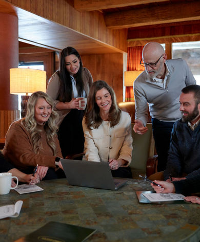 Coworkers Collaborating in Meeting Room at Seven Springs