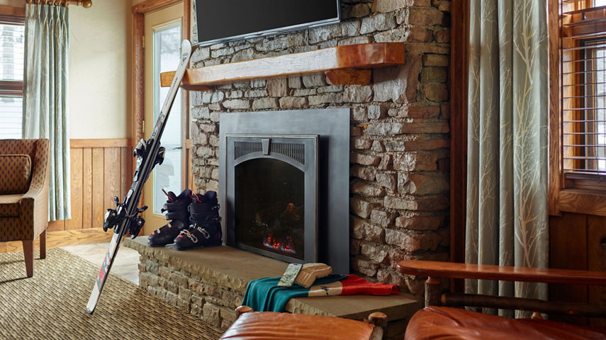 Interior Detail of Ski Gear Gathered around Fireplace at Sevens Springs Birch Chalet