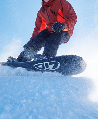 Snowboarder Carving Down Mountain at Park City