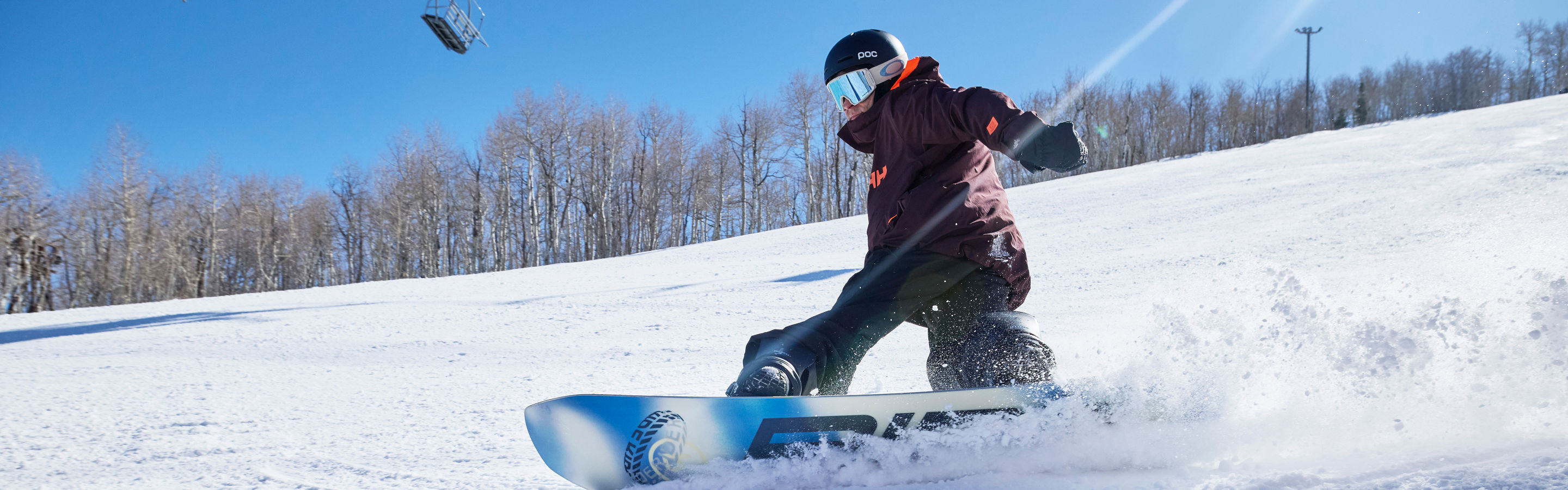 Snowboarder Carving Down Mountain at Park City