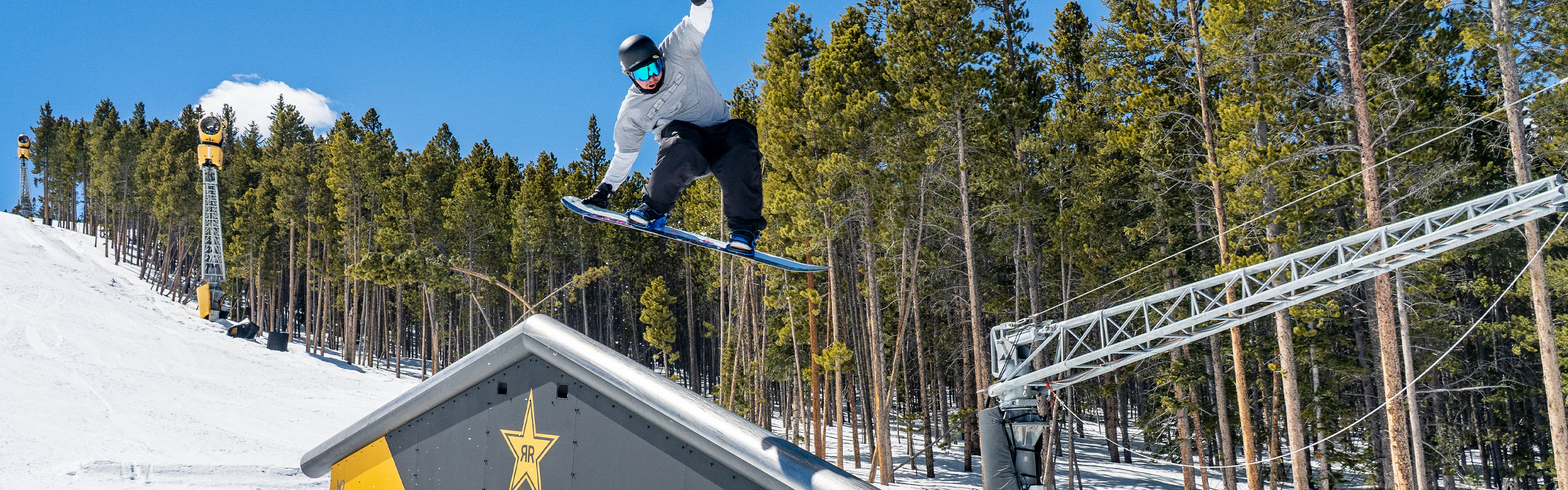 Snowboarder Jumps on Rail at Breckenridge Terrain Park