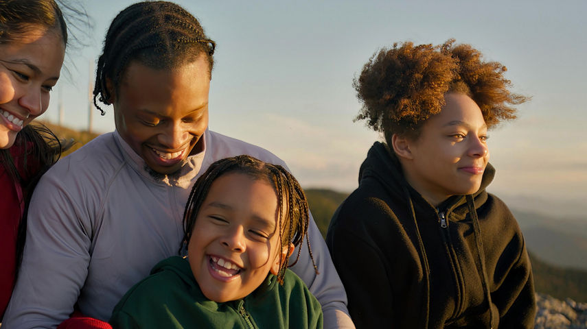 Family Cuddling Up After Hike on Summit at Stowe