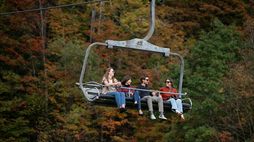 Group of Friends Taking Scenic Chairlift Ride at Seven Springs