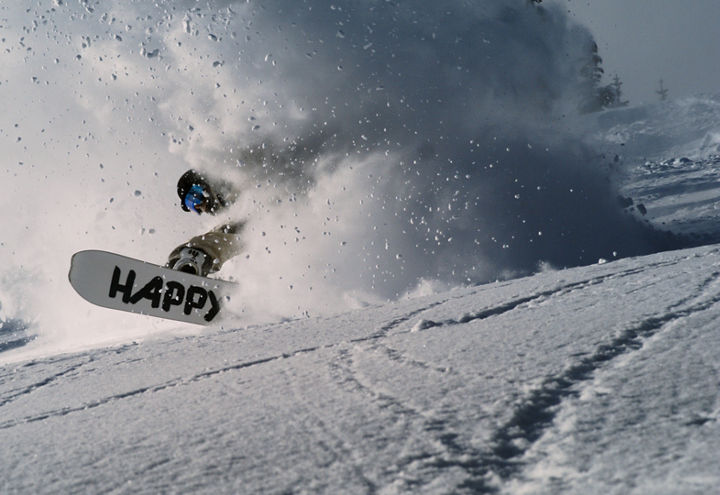 Close-Up of Snowboarder Crashing Through Powder Cloud