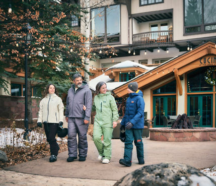 Family Leaving Lodge at Vail with Ski Gear