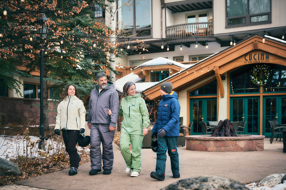 Family Leaving Lodge at Vail with Ski Gear