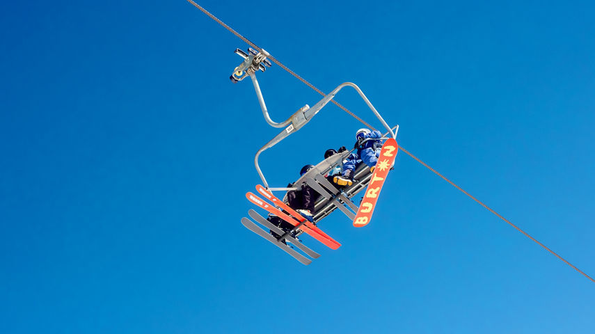 Family Chairlift Ride Under Clear Colorado Sky
