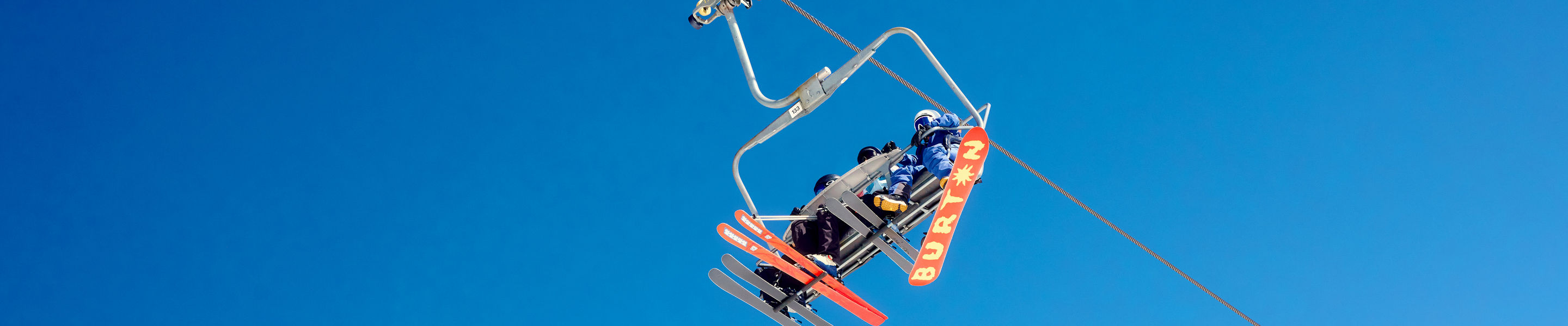 Family Chairlift Ride Under Clear Colorado Sky