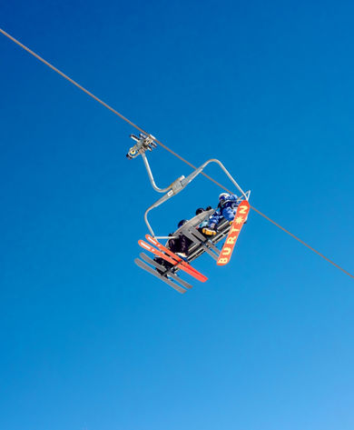 Family Chairlift Ride Under Clear Colorado Sky