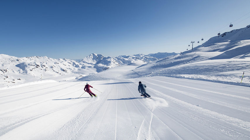 Couple Skiing Down Mountain at Zillertal