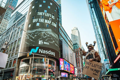 Ullr Holding "They Left Us Off The Map" and Pointing to Times Square Billboard in New York City