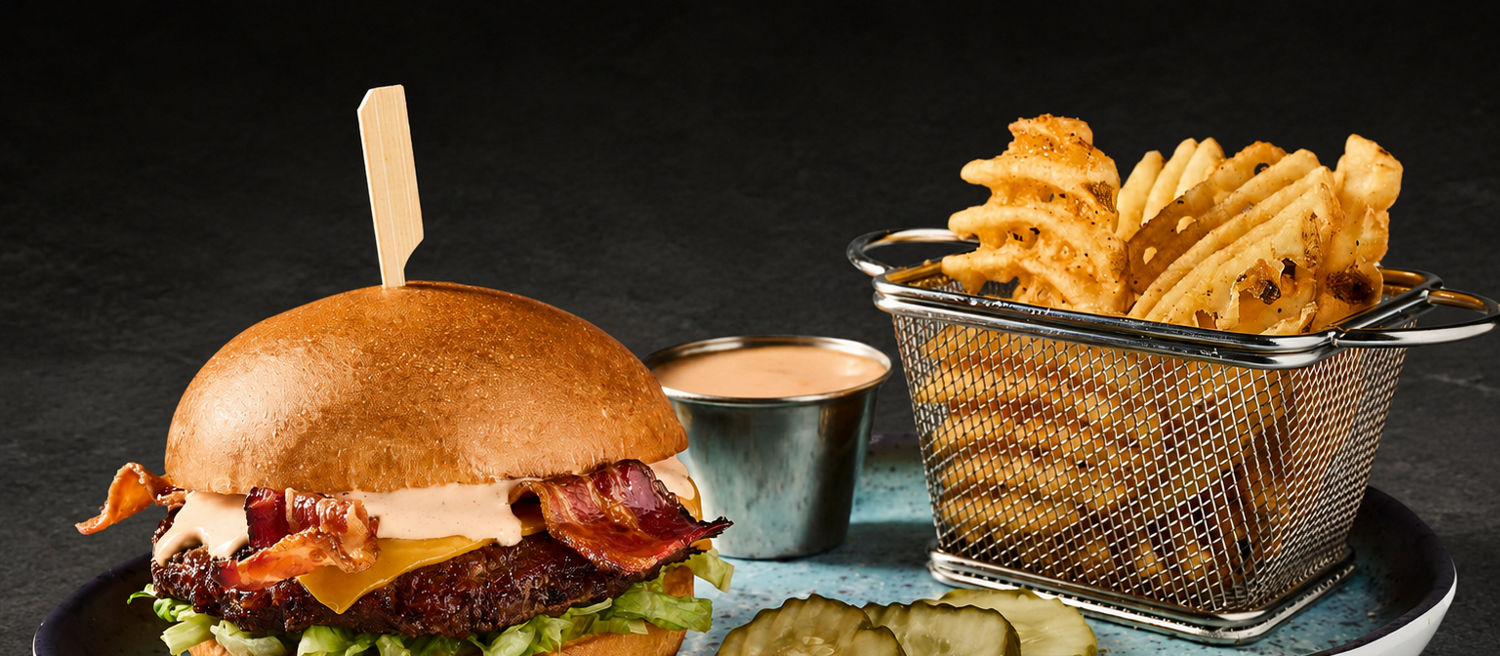 The Steakhouse Burger with Bacon and Waffle Fries with Slate Background