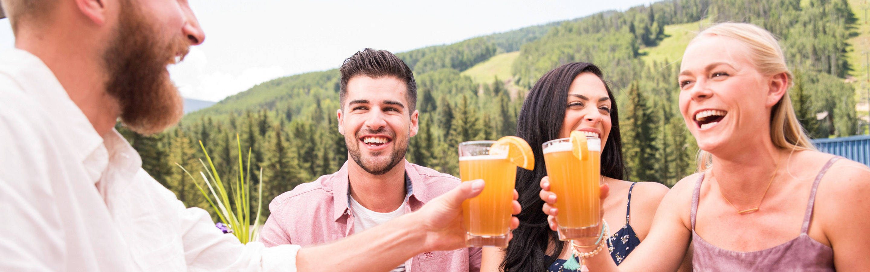Friends drink beer outdoors in Vail, CO.