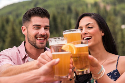 Friends drink beer outdoors in Vail, CO.
