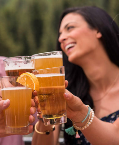 Friends drink beer outdoors in Vail, CO.