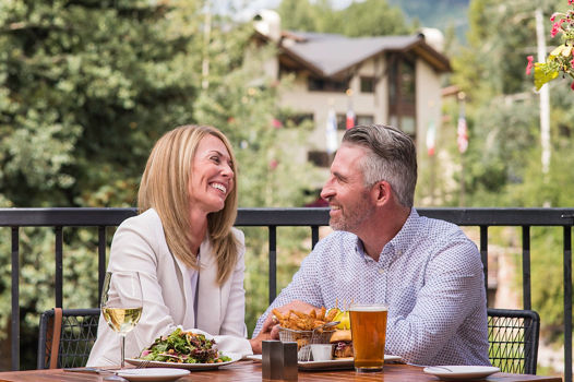 Couple dining on an outdoor patio in Vail, CO.