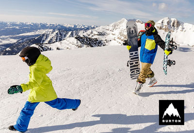 2 Snowboarders wearing Burton gear and boards on mountain