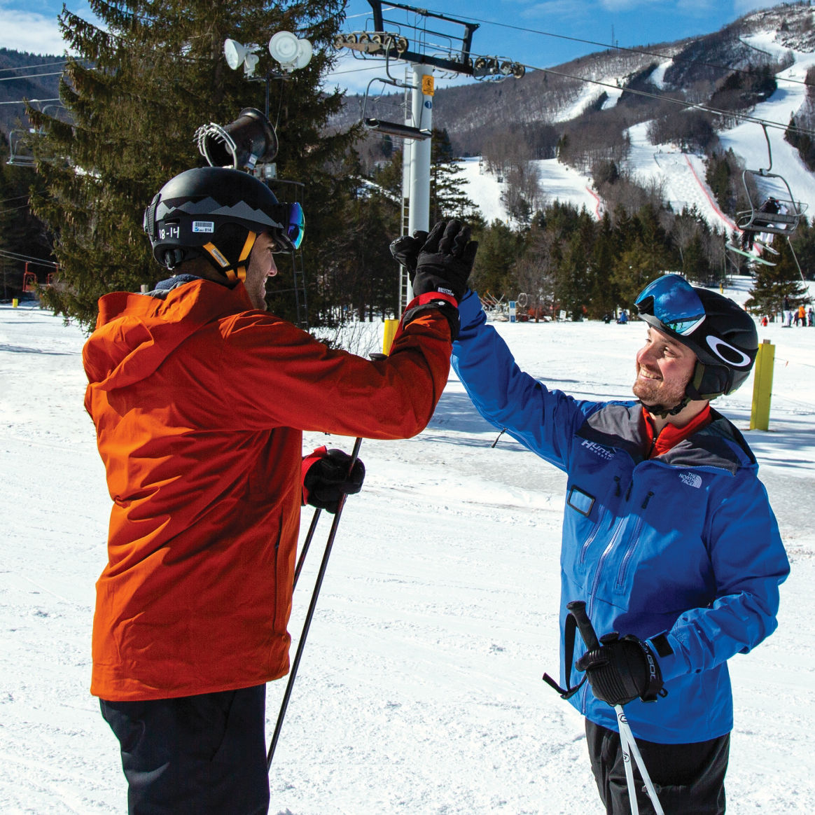 Skier and instructor high five
