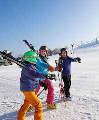 Three Skiers Walking 