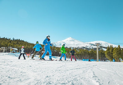 A ski school group skis beginner terrain at Breckenridge