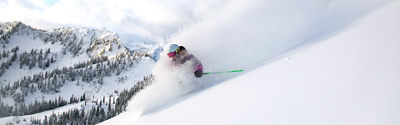 Woman Skiing Powder at Aquarius Face at Stevens Pass