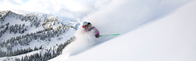 Woman Skiing Powder at Aquarius Face at Stevens Pass