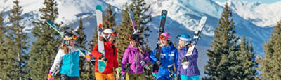 Group of women carry their skis in Vail, Colorado