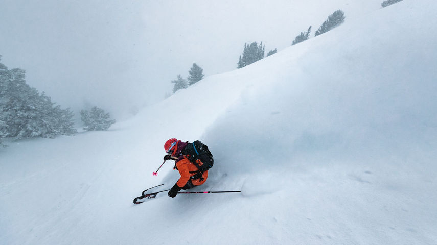 Skier wearing Patagonia gear skiing down mountain