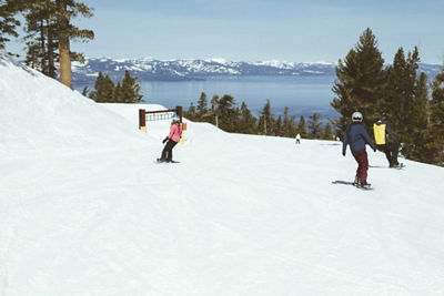 Skiers skiing down mountain