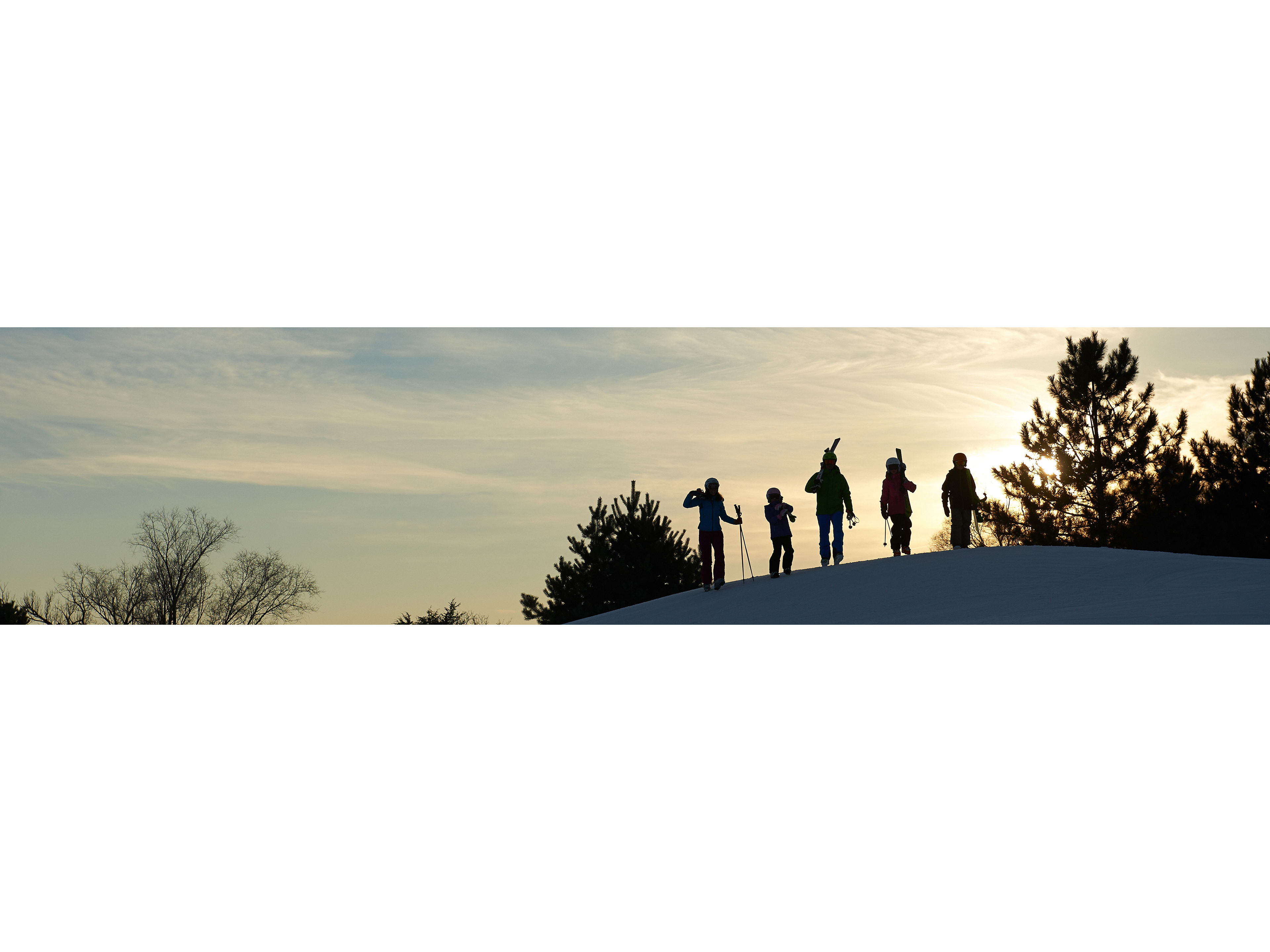 Friends Walking With Skis During Sunset At Afton Alps, MN