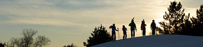 Friends Walking With Skis During Sunset At Afton Alps, MN