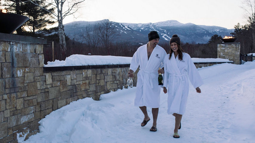 Couple walks to the spa in Stowe, VT.