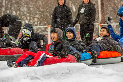 Families and Friends Tubing During Totally Tubular 80's Event at Wilmot Mountain